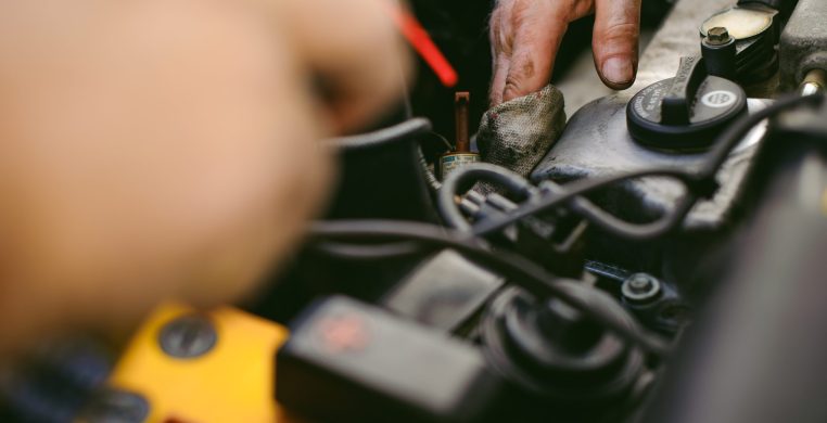 hands of an auto mechanic close-up. servicing and caring for a car engine